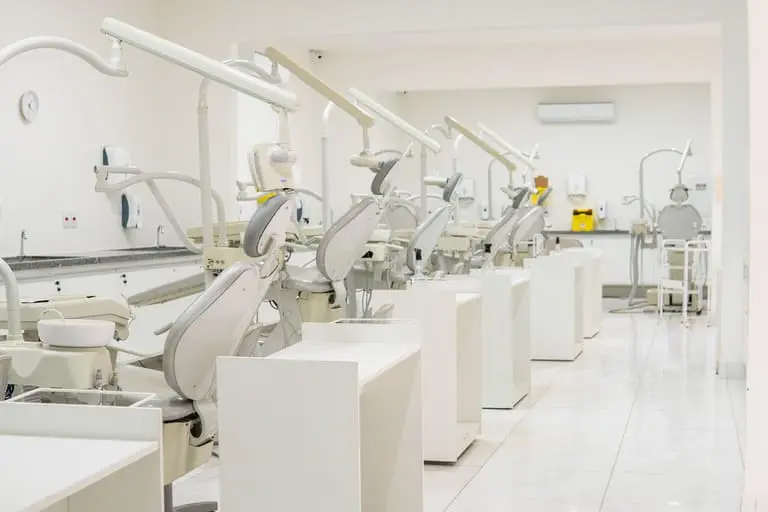 A row of dental units along the wall of the Brazilian teaching clinic